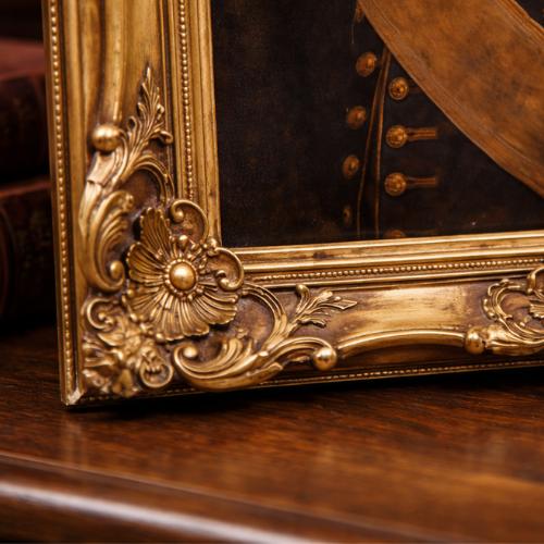 Decorative gold frame with intricate designs on a wooden surface heritage pawzy portrait